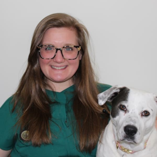 Dr. Sarah Gorman, Owner and Veterinarian, smiling beside her dog Emmah.